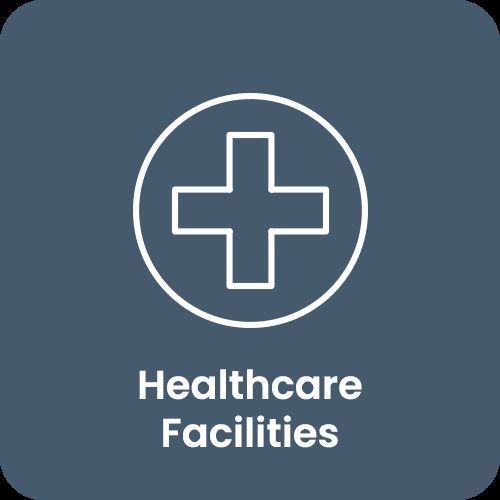 Healthcare facilities icon with a white cross on a blue background.